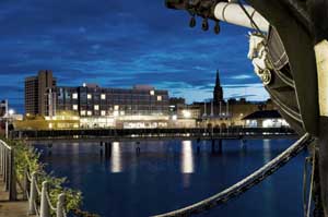 Photograph of the Apex Hotel and Frigate Unicorn at night